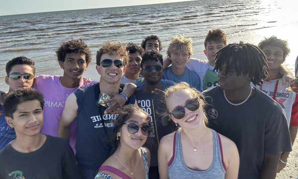 ECO club takes a photo together on the beach.